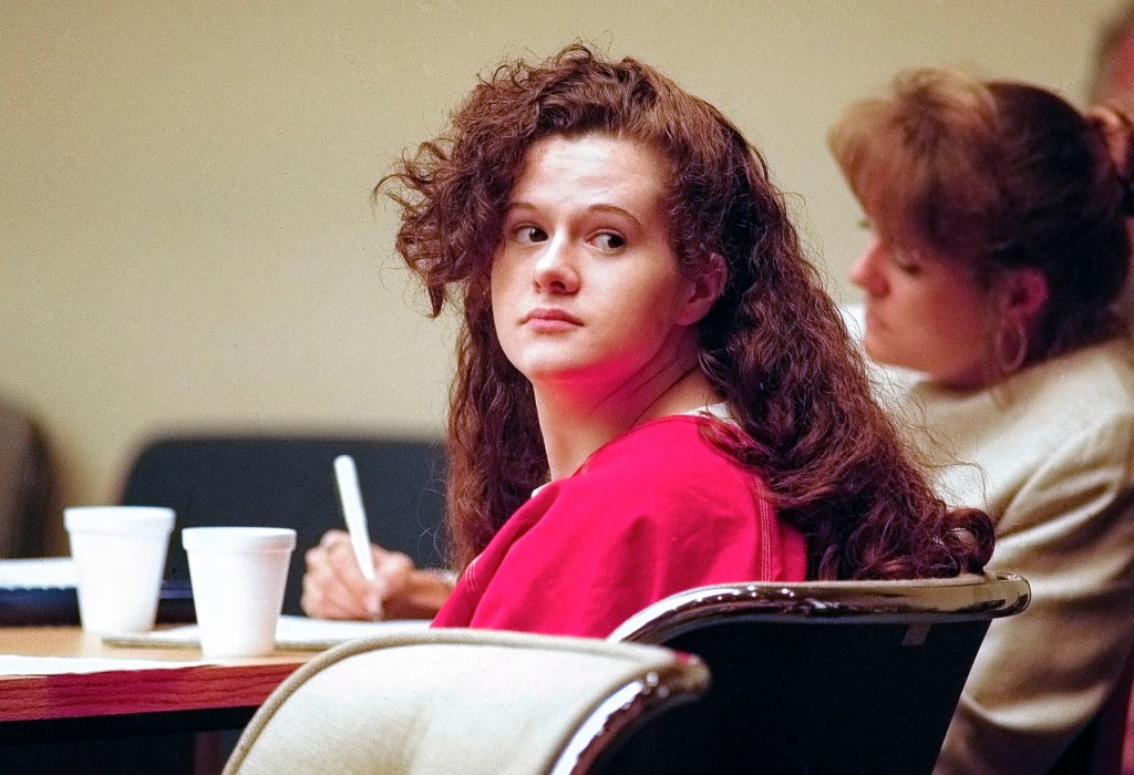 Christa Gail Pike looking over her shoulder in a courtroom.