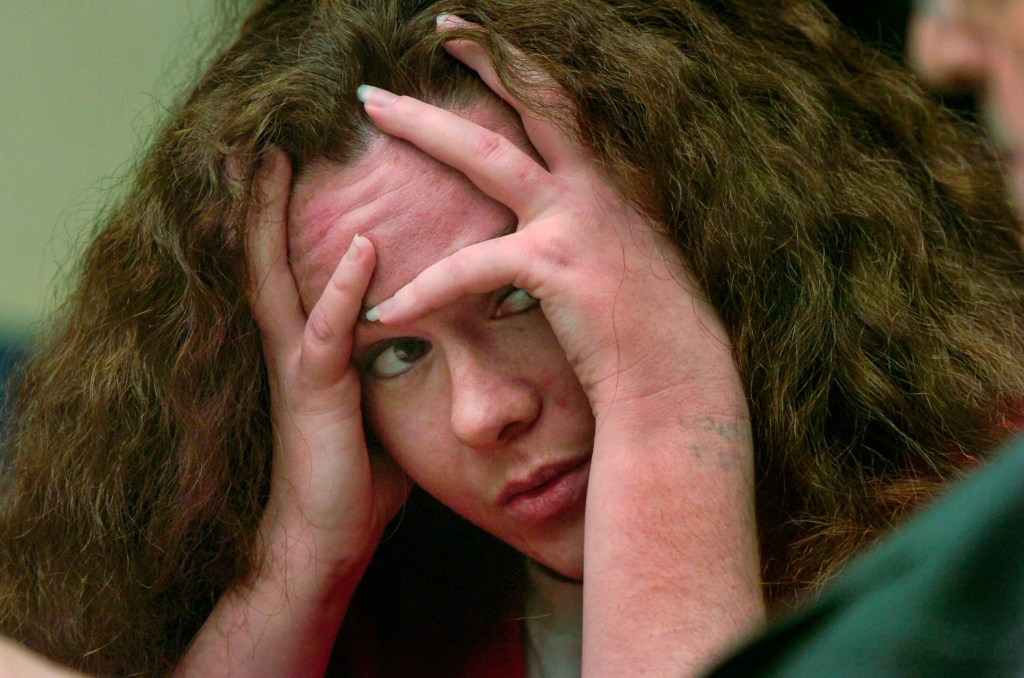 Christa Gail Pike listening to her mother testify in court.